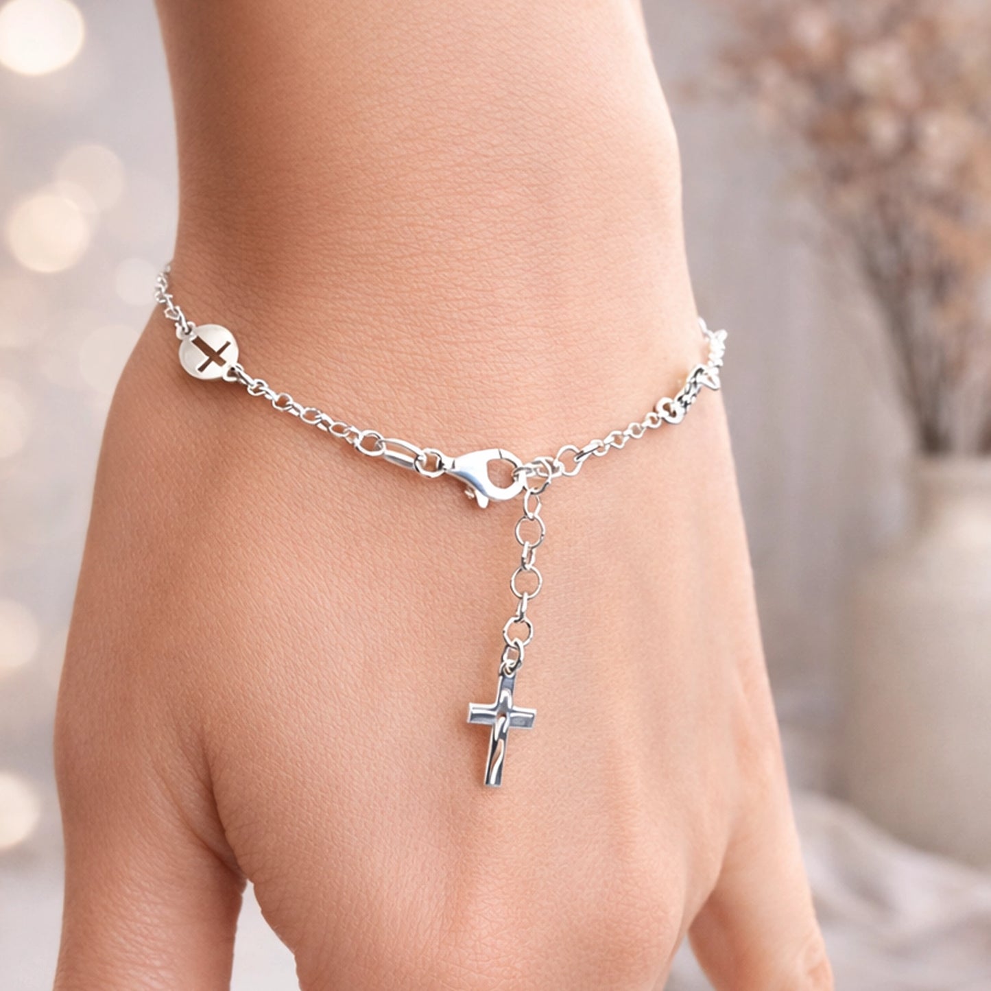 Christian sterling silver dangle cross lariat bracelet on wrist, adjustable chain with lobster clasp and minimalist cross charm for everyday faith jewelry