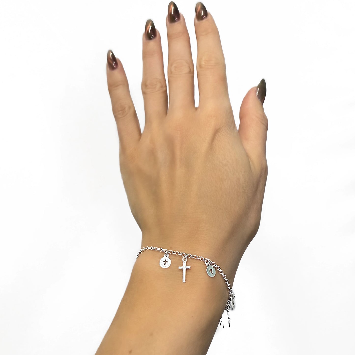 Stylish sterling silver religious bracelet with dangling cross charms showcased on a woman's hand, designed with a lightweight chain and faith-inspired accents for a modern, elegant style