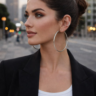 terling silver oversized hoop earrings on model, minimalist statement earrings close-up jewelry photo