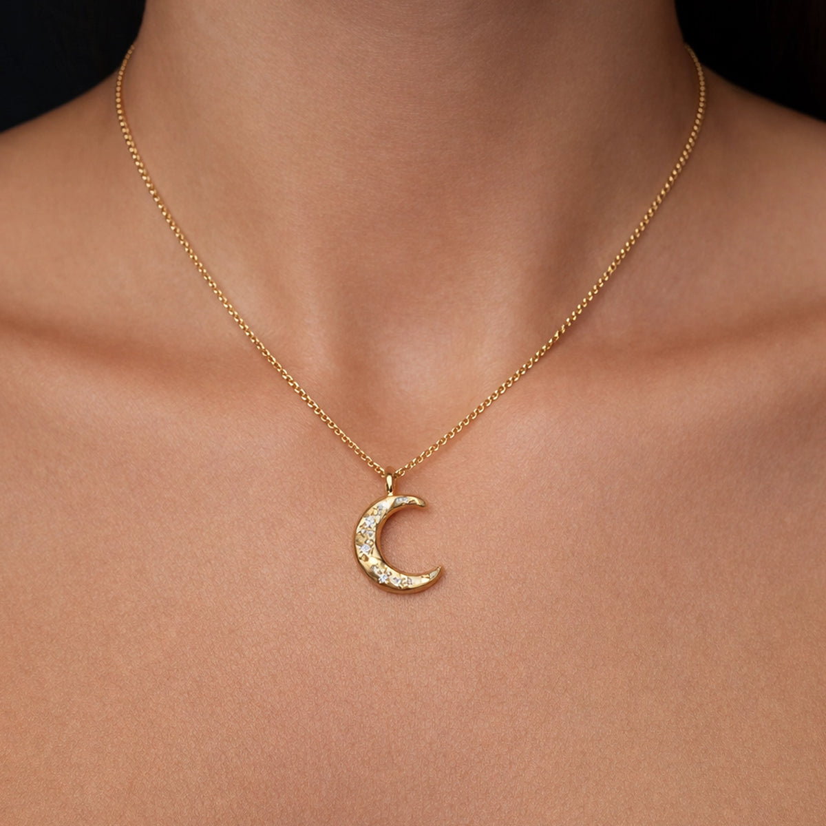 Gold filled crescent moon necklace with sparkling CZ stones on a delicate gold chain, celestial minimalist pendant jewelry worn on a model’s neck, elegant moon charm necklace for everyday style and layering.