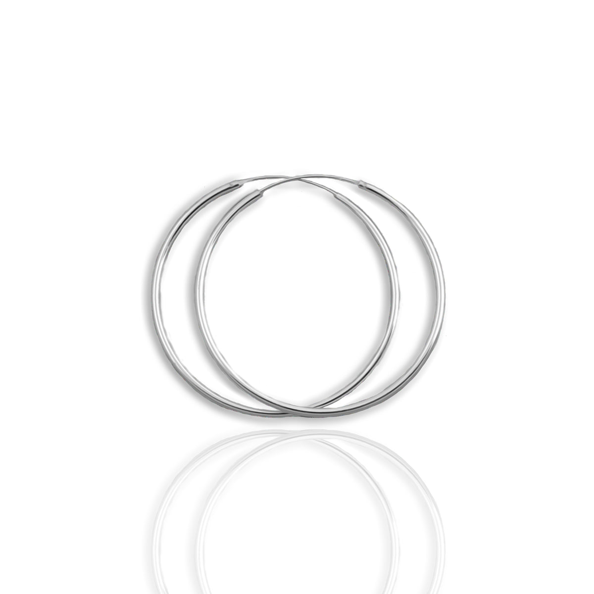 A pair of continuous hoop earrings made of sterling silver, displayed against a white background with a reflective surface below.