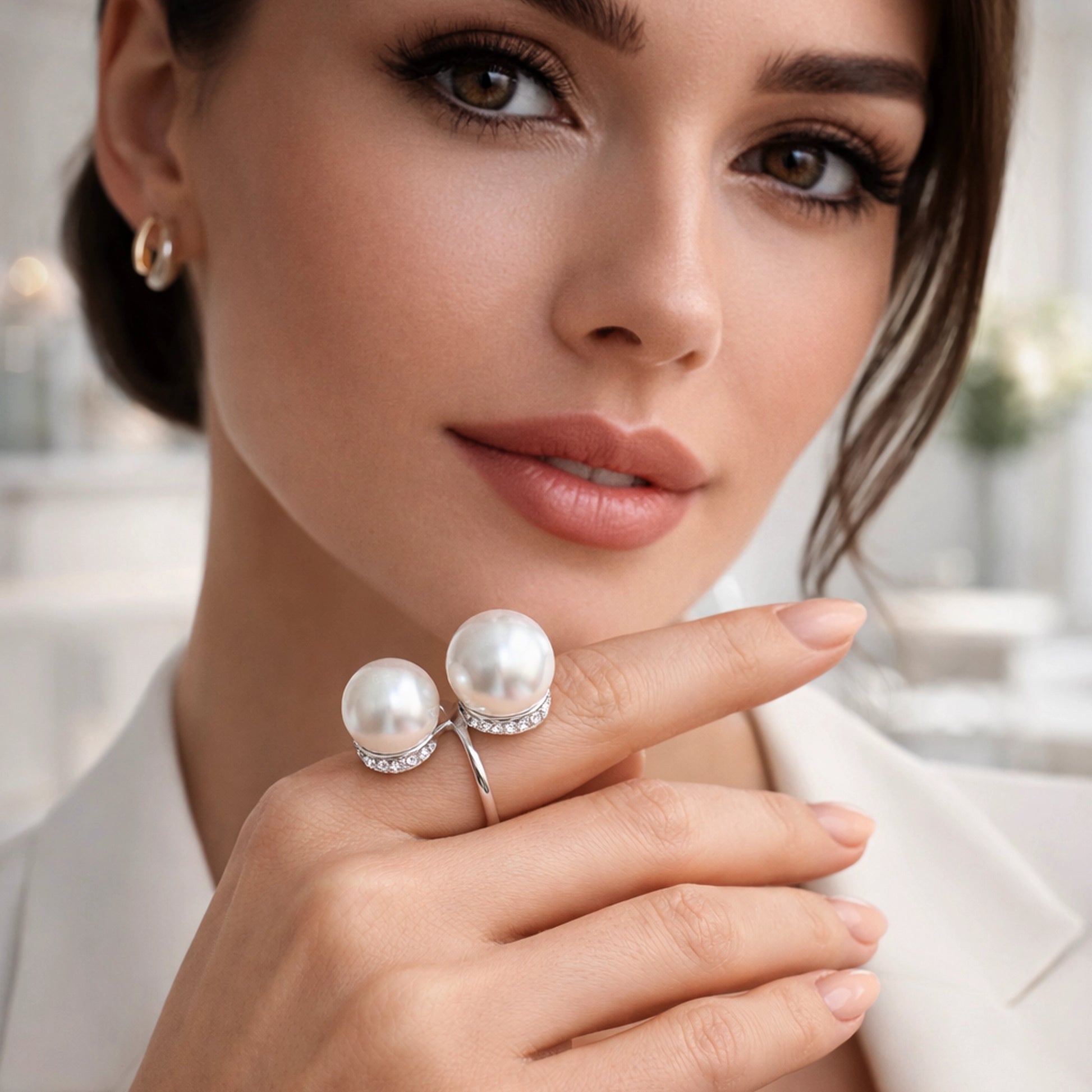 Elegant double pearl ring with sparkling pavé diamond accents on a beautiful model, professional studio lighting, luxury jewelry close-up, modern stylish portrait, white pearls and silver band, high-end fashion accessory.