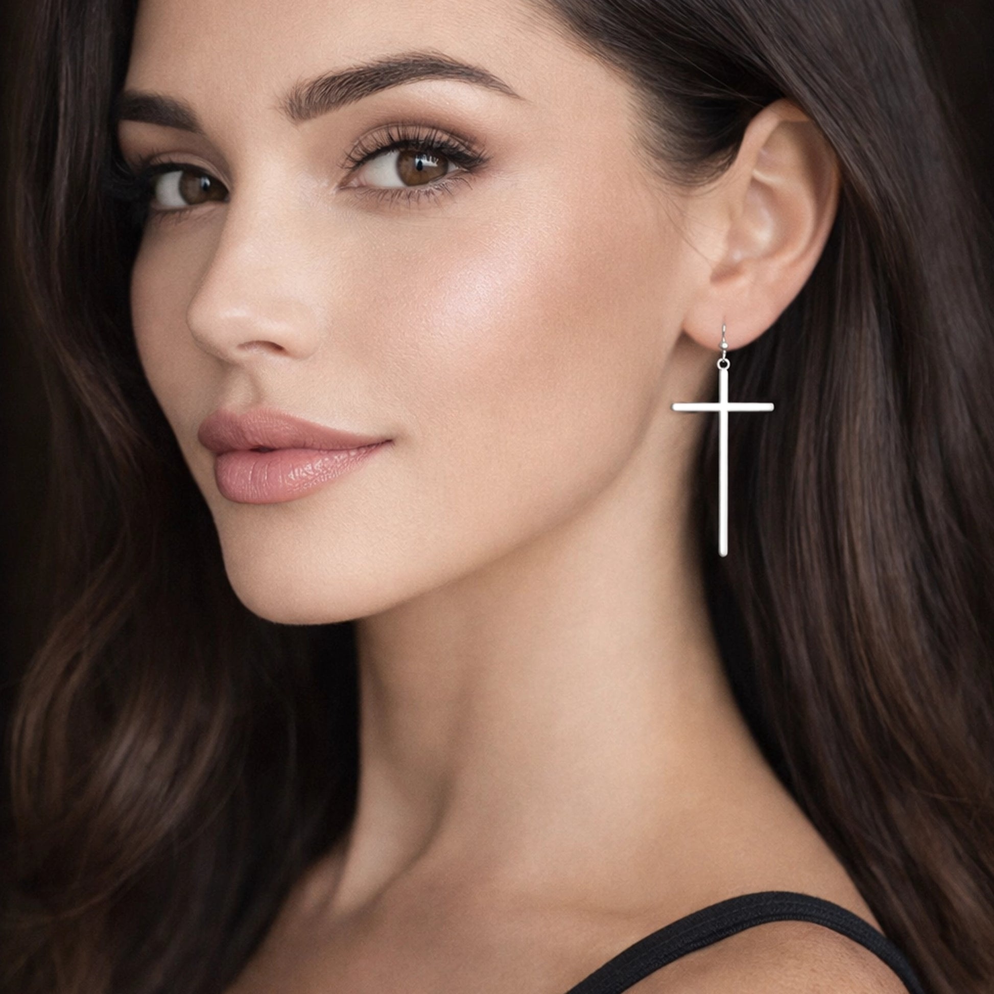 Long minimalist silver cross drop earrings worn by woman, elegant Christian faith jewelry with sleek vertical cross design