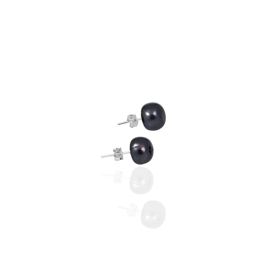 Studio product shot of dark blue freshwater pearl stud earrings with sterling silver posts and butterfly backs, reflected on a white glossy surface.