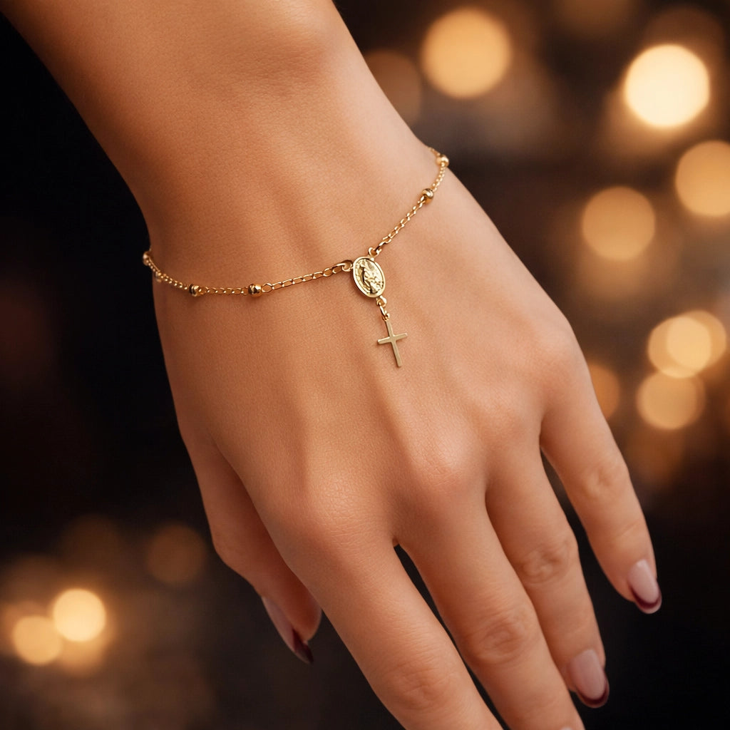 Gold filled rosary bracelet with Virgin Mary medallion and cross charm on woman’s wrist, close-up hand shot, smooth skin, elegant manicure, professional studio lighting, luxury religious jewelry, square photo