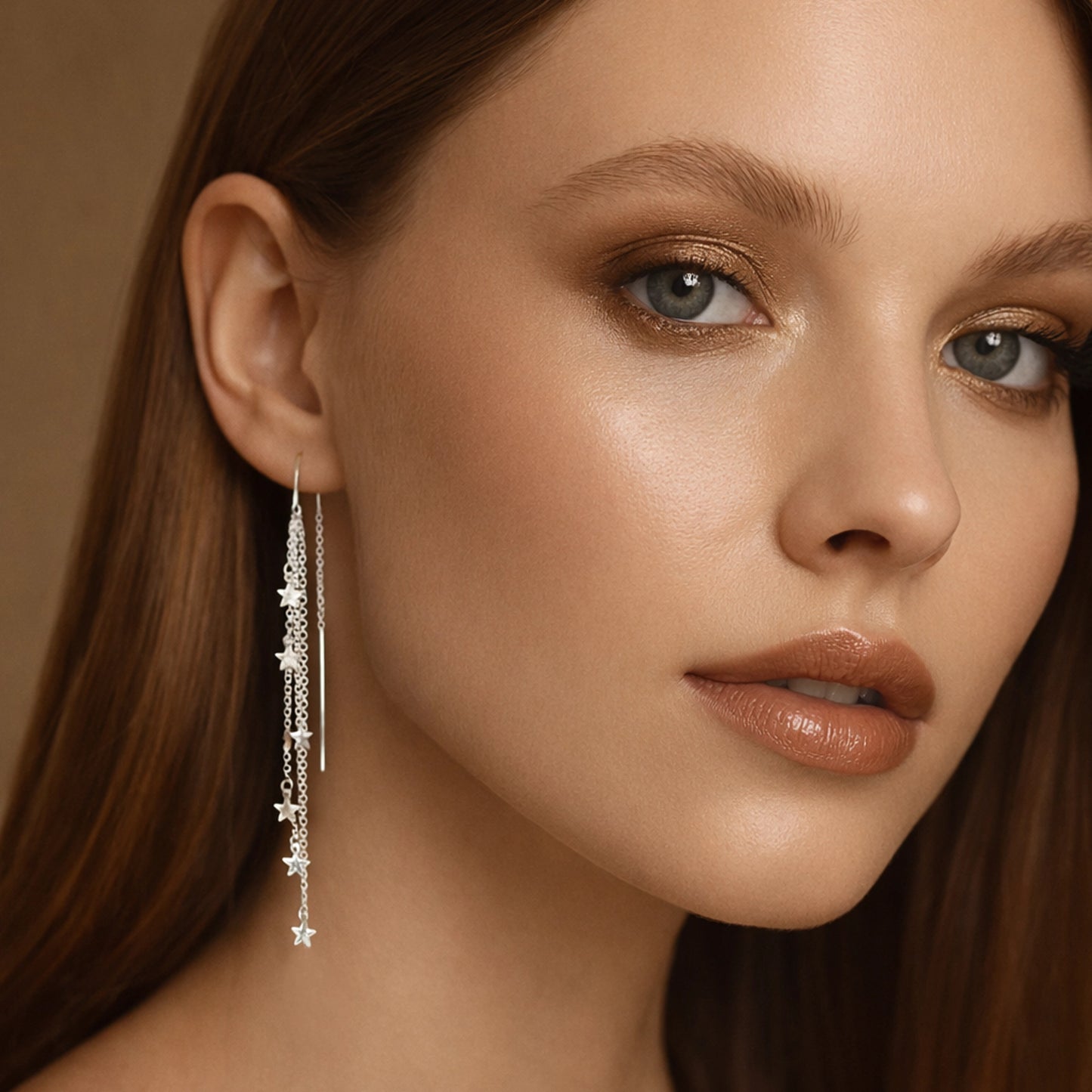 Model wearing sterling silver star threader earrings with long dangle chain.