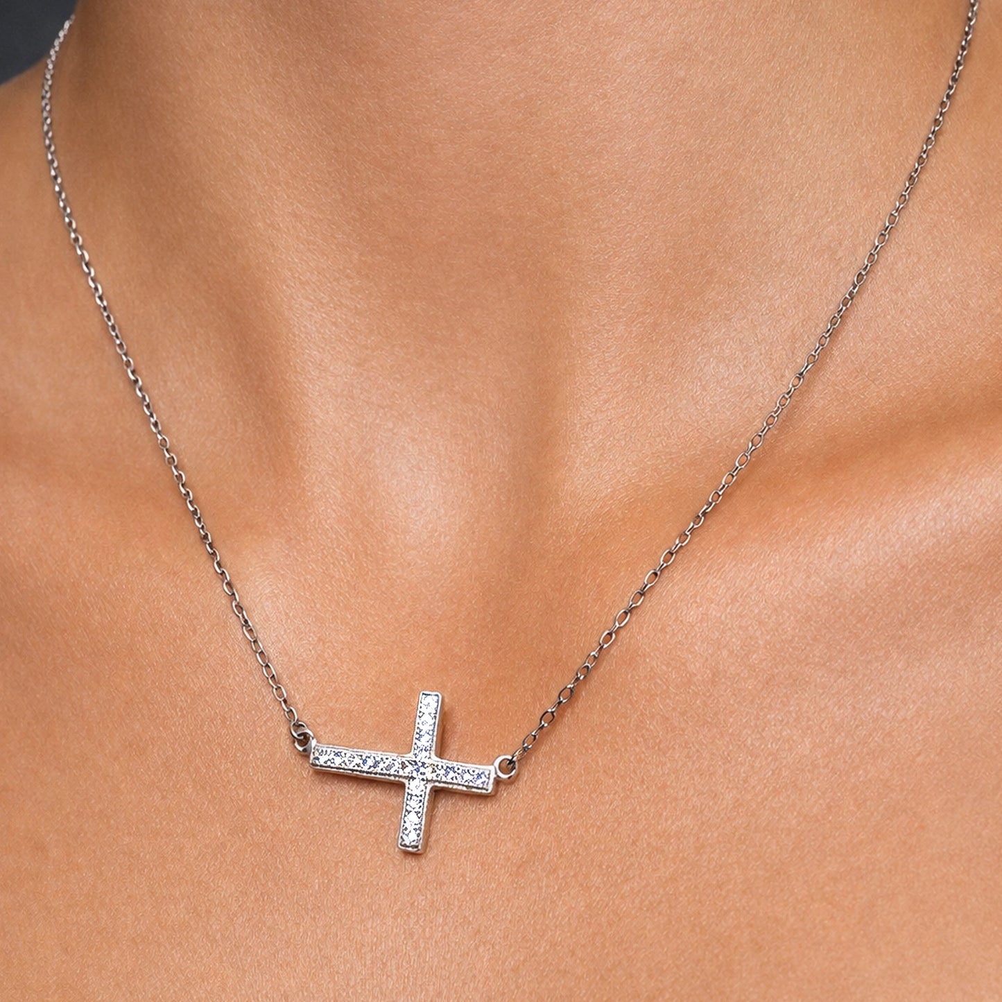 sterling Silver sideways cz cross necklace on a women's neck