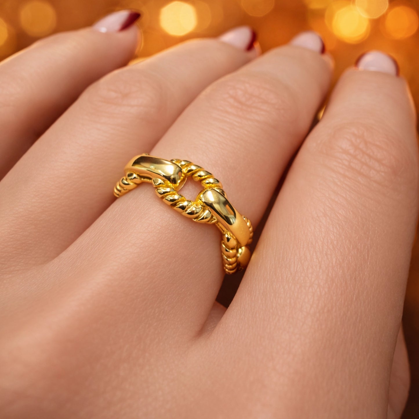 Gold filled braided rope chevron ring on woman’s hand, elegant twisted V-shape stacking ring with polished gold finish, minimalist modern jewelry for everyday wear and stacking