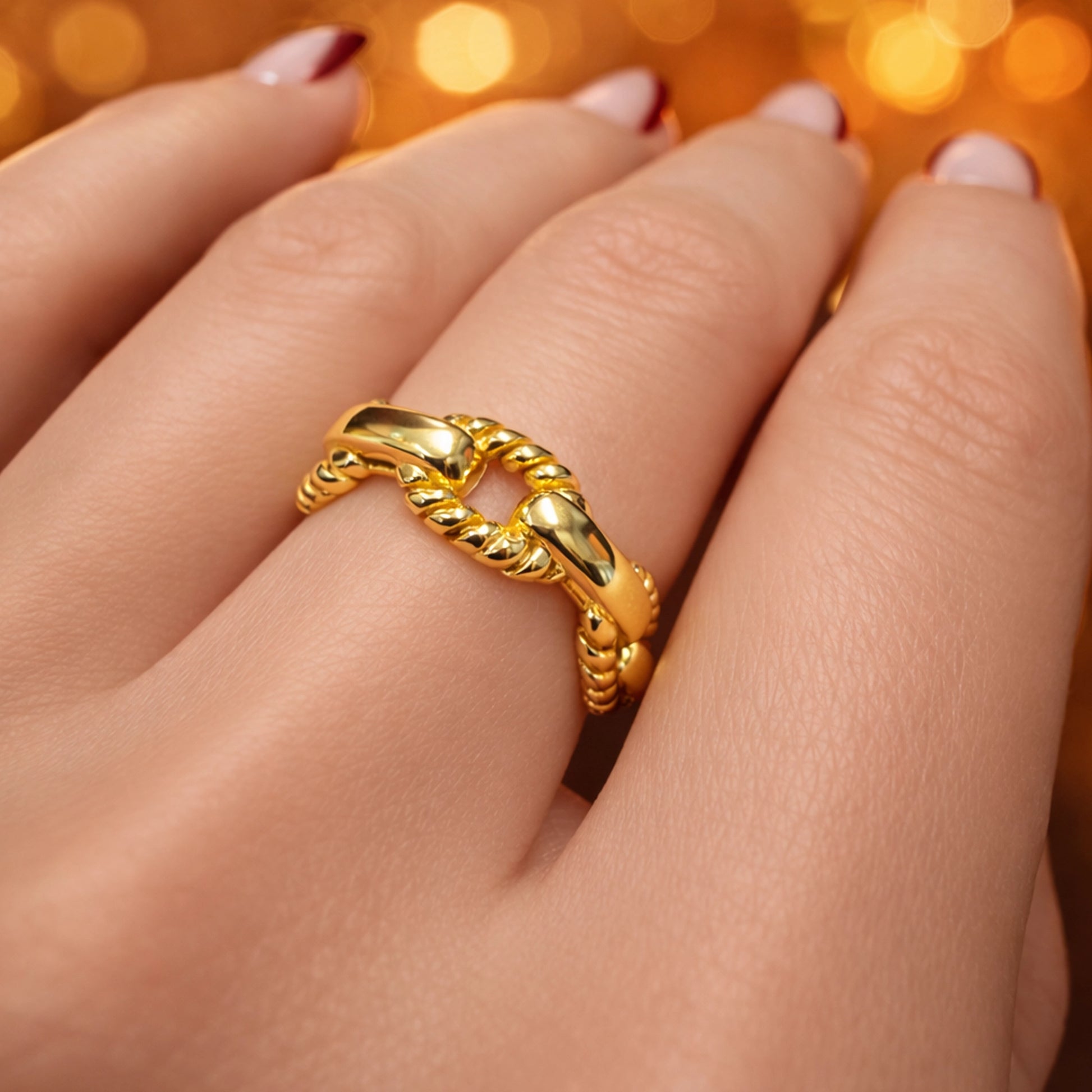 Gold filled braided rope chevron ring on woman’s hand, elegant twisted V-shape stacking ring with polished gold finish, minimalist modern jewelry for everyday wear and stacking