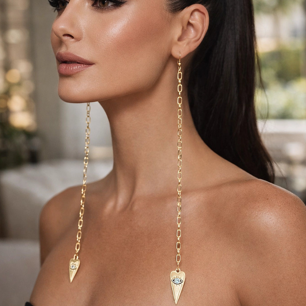 Evil Eye Long Chain Drop Earrings in 18K Gold plated brass with oval link chain, modern protective evil eye charm earrings, elegant statement jewelry worn by model with sleek ponytail.
