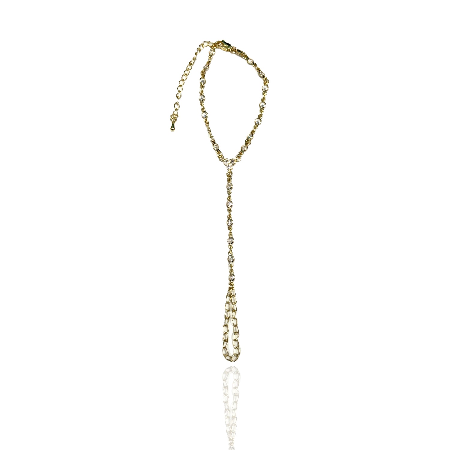 Elegant gold filled hand chain with sparkling CZ stones laid flat on a white background, highlighting the minimalist design and structure.
