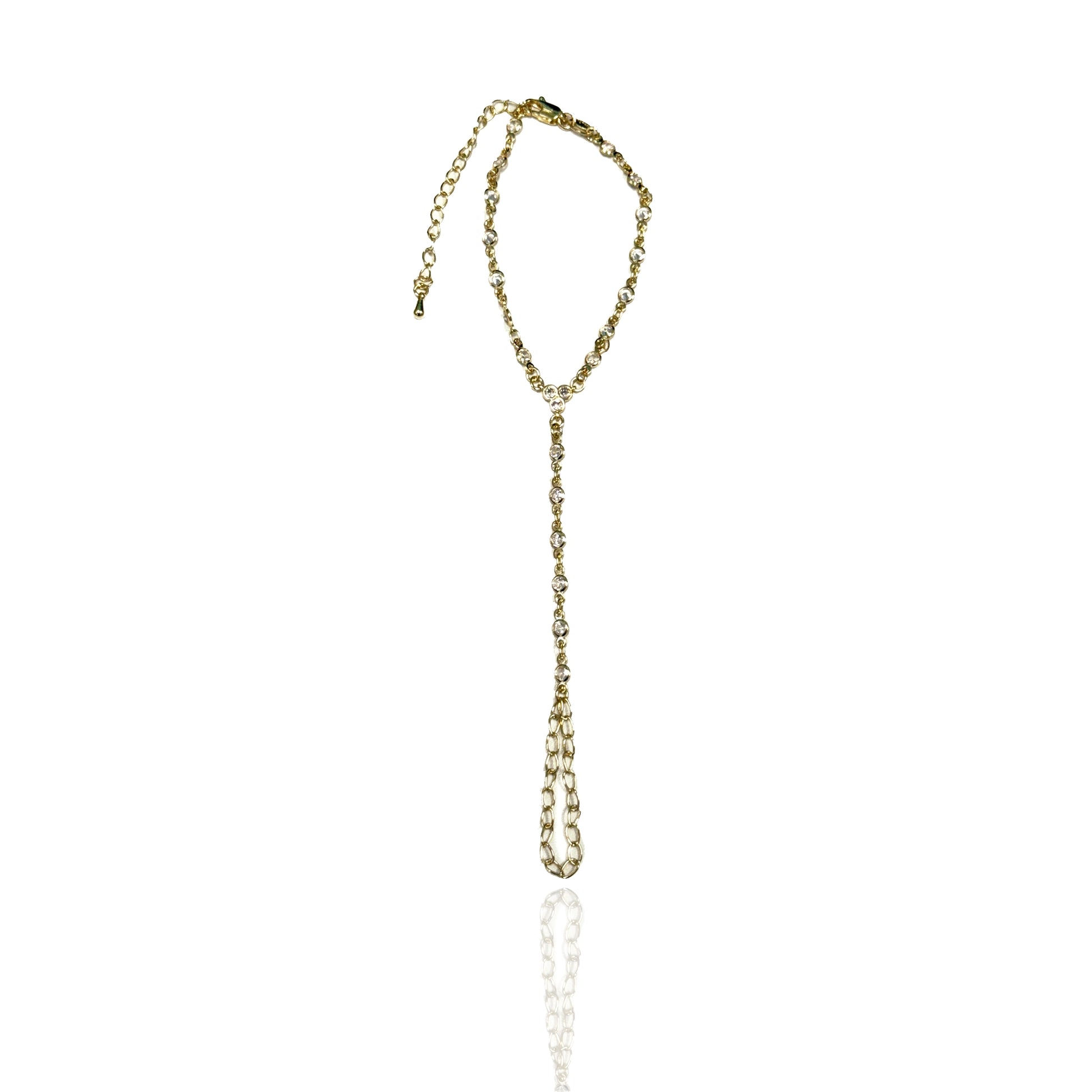 Elegant gold filled hand chain with sparkling CZ stones laid flat on a white background, highlighting the minimalist design and structure.