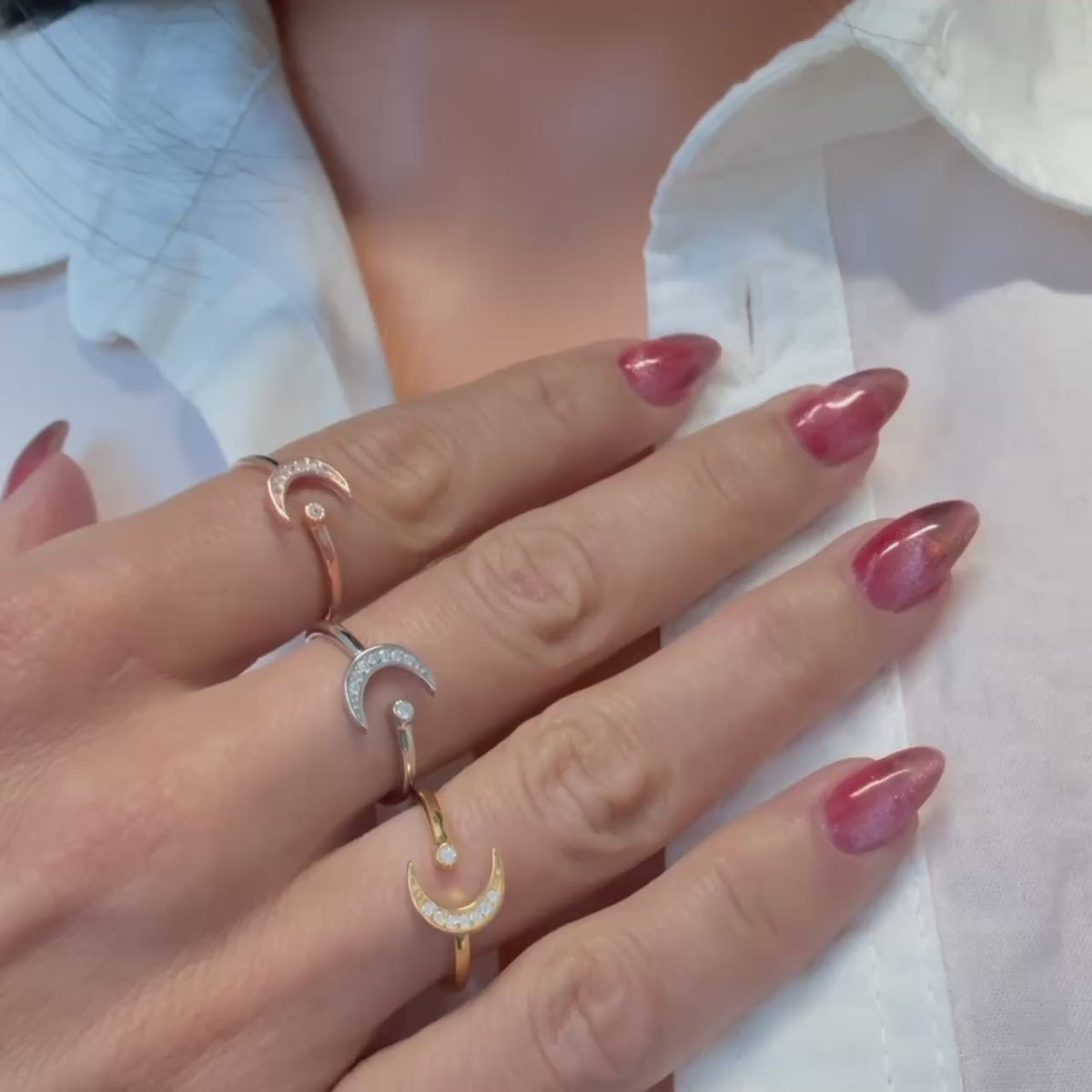 Video showing three adjustable sterling silver crescent moon and star rings in gold, silver, and rose gold finishes. Each open ring sparkles with cubic zirconia accents and features a delicate celestial design worn on manicured fingers.