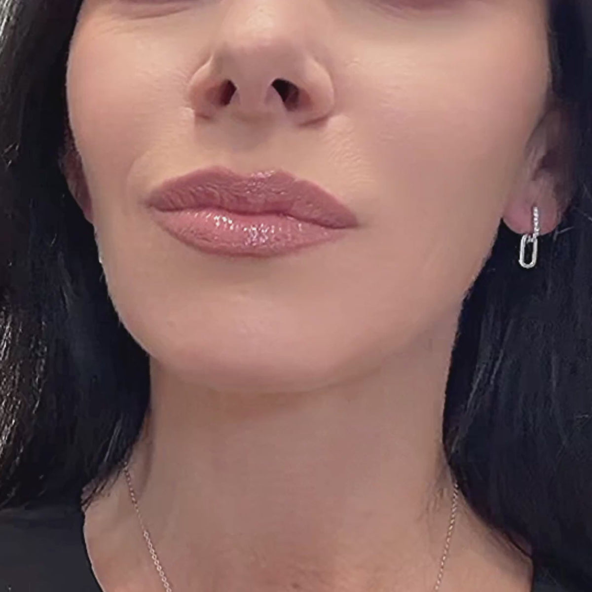 Video of sterling silver double chain link huggie hoop earrings with cubic zirconia, shown from various angles to highlight their sparkle, link movement, and polished finish against a clean background.