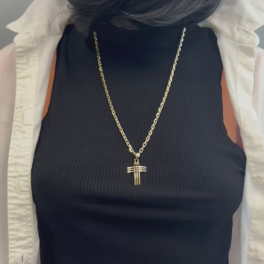 Slow-motion video of a unisex 18k gold filled cross necklace gently rotating, highlighting the polished surface and elegant detailing of the cross pendant on a sleek cable chain, displayed against a clean white background.