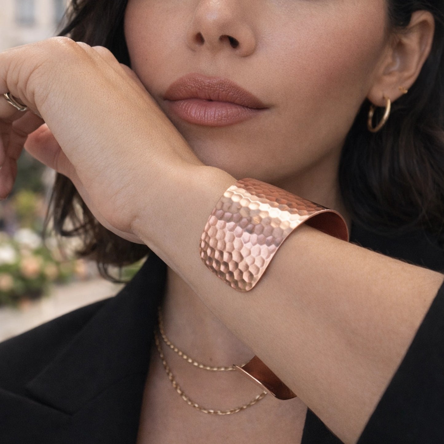 Close-up view of hammered copper cuff bracelet showing textured hand-hammered surface and smooth polished edges