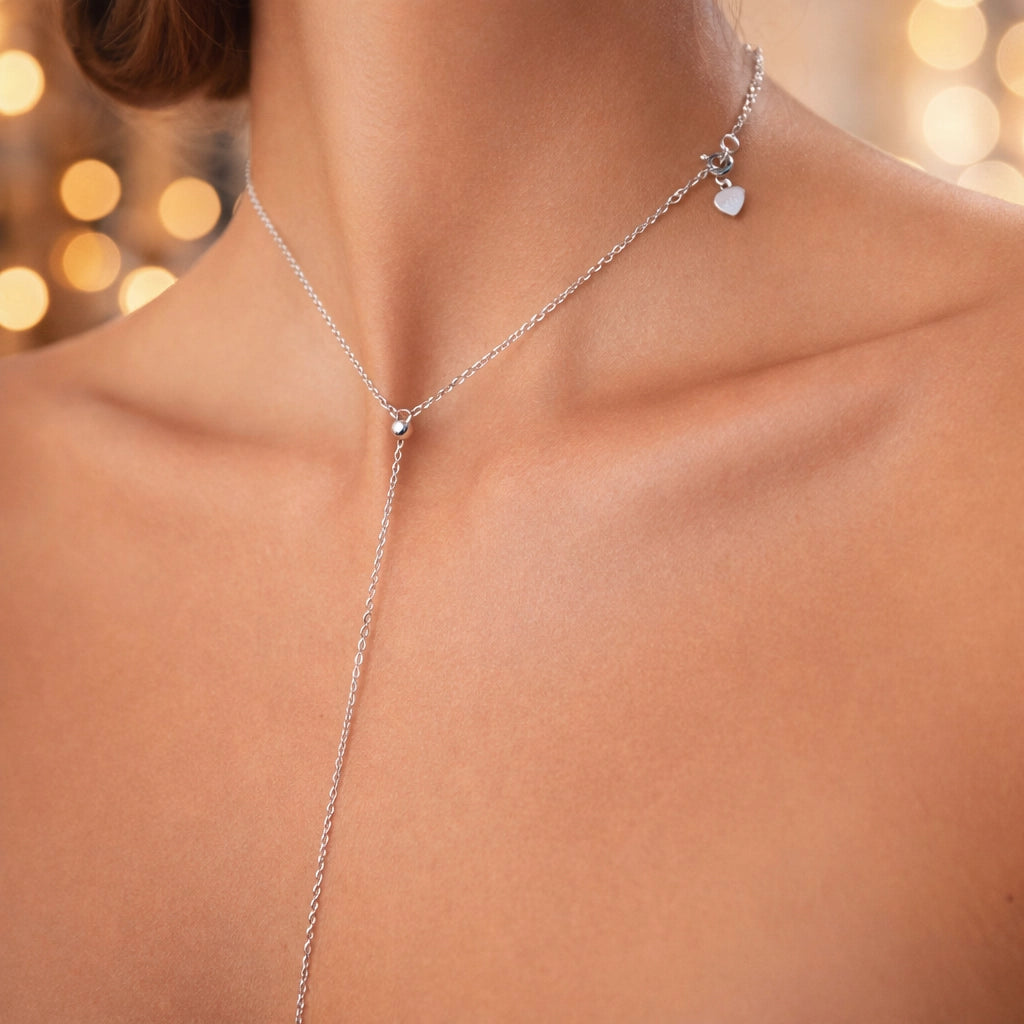 Slider bead lariat cross necklace in sterling silver, modern religious jewelry worn on model with elegant neckline