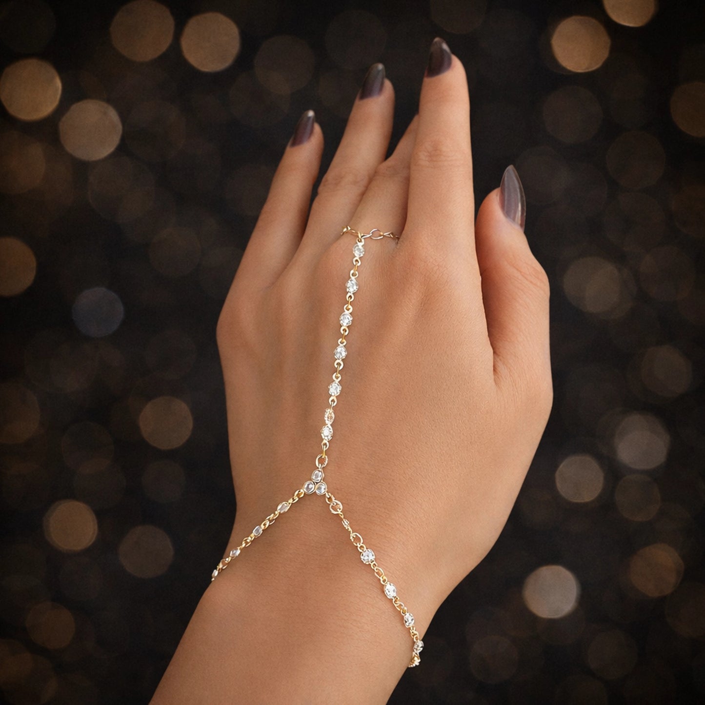 Delicate gold hand chain bracelet with cubic zirconia, slave bracelet with ring, minimalist luxury hand jewelry for women, elegant gold hand chain close-up