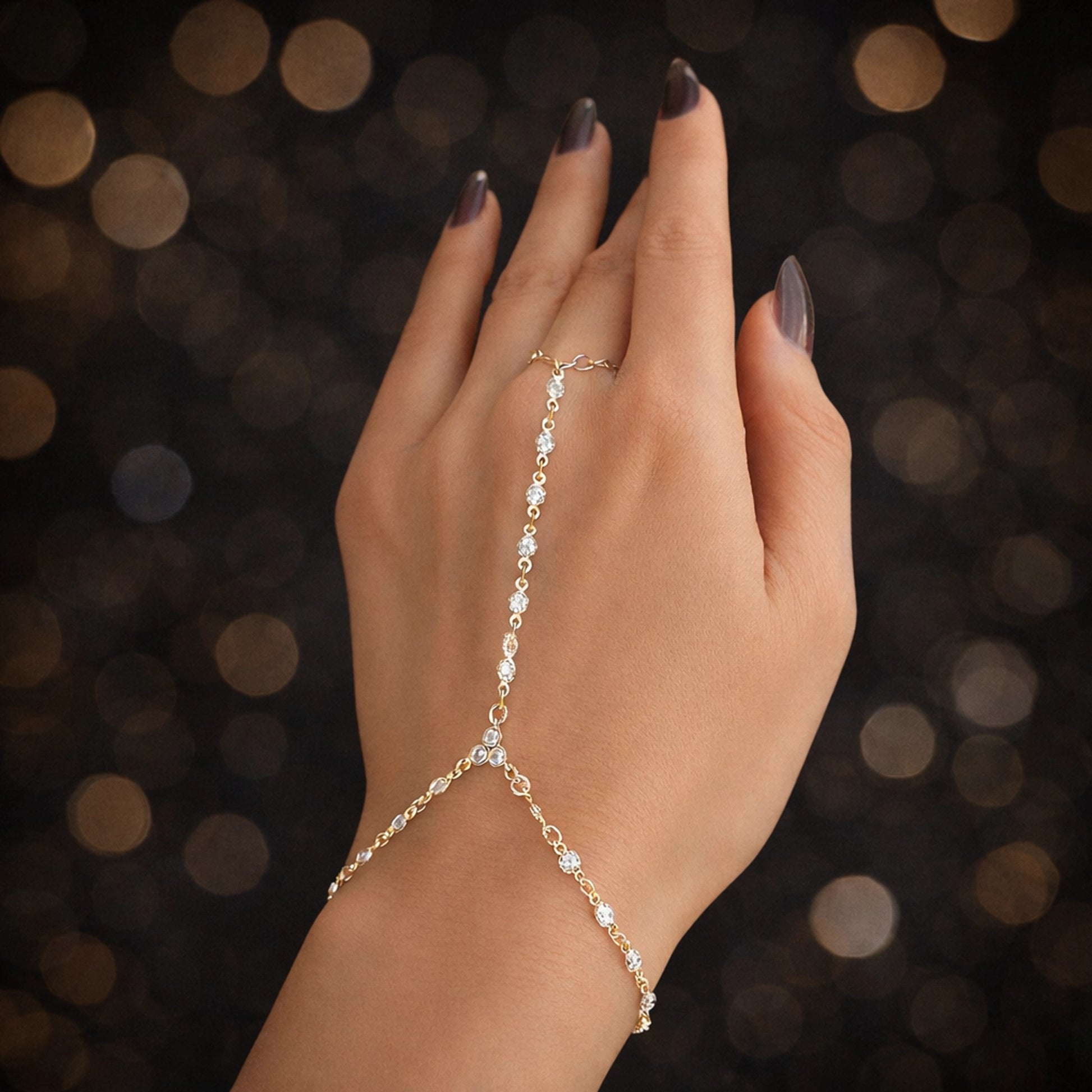 Delicate gold hand chain bracelet with cubic zirconia, slave bracelet with ring, minimalist luxury hand jewelry for women, elegant gold hand chain close-up