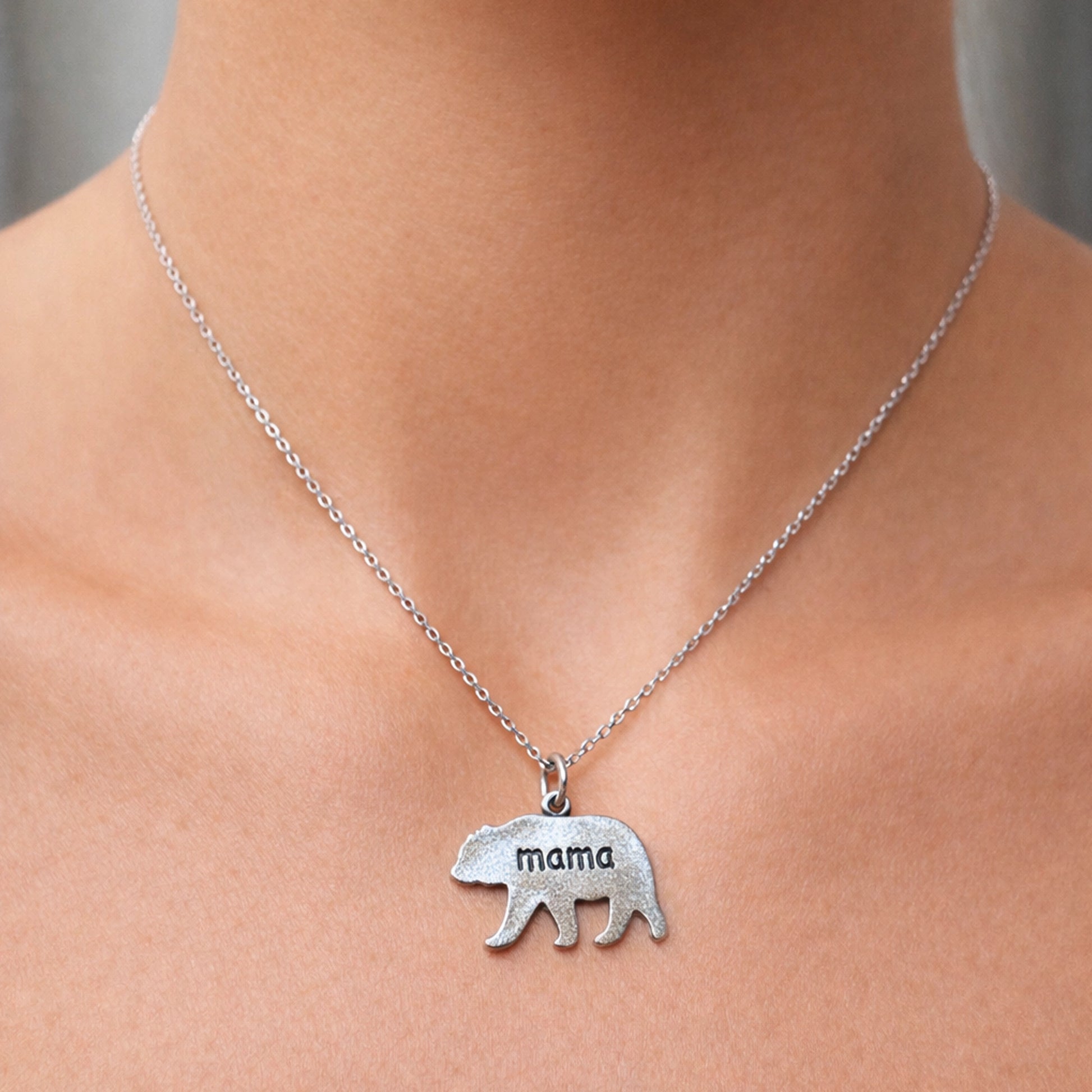 Sterling silver mama bear engraved necklace on woman’s neck, minimalist bear pendant jewelry for mom, personalized silver mother necklace gift for Mother’s Day or birthday