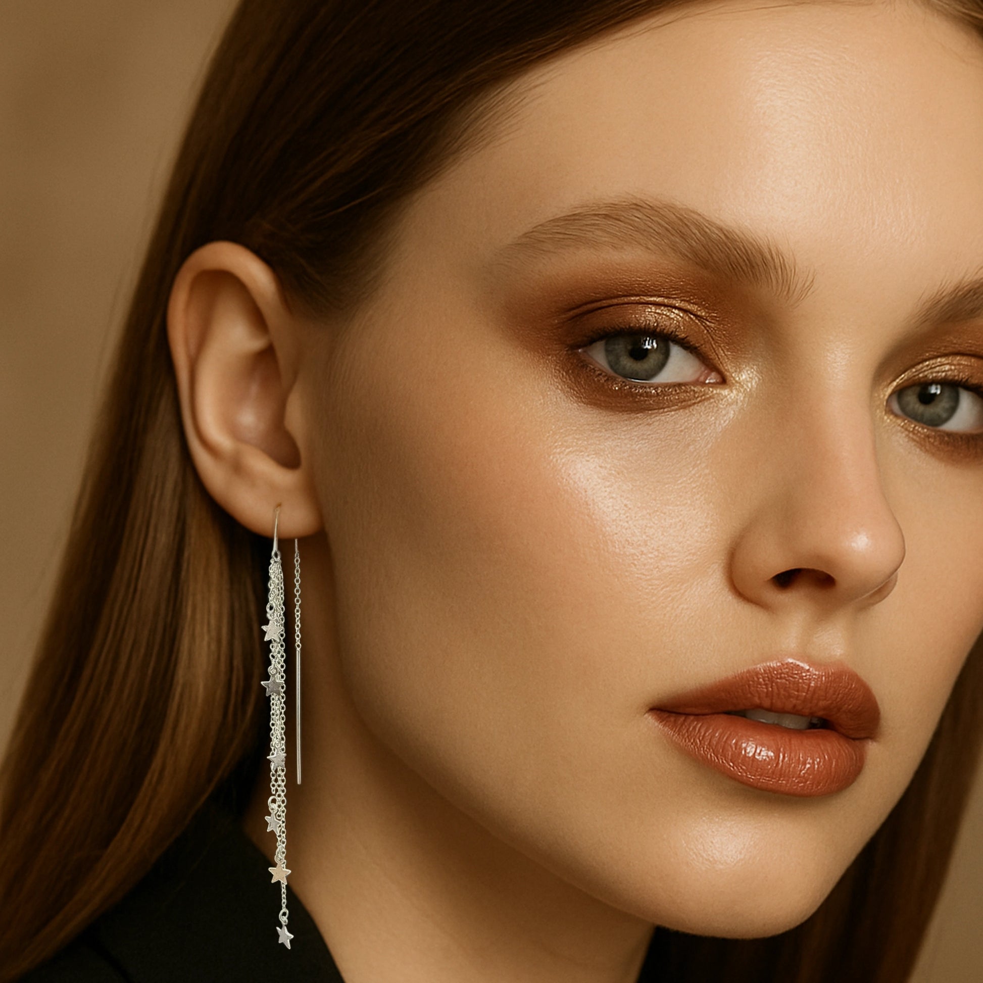 Model wearing sterling silver star threader earrings with long dangle chain.